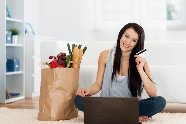 Young woman buying groceries online