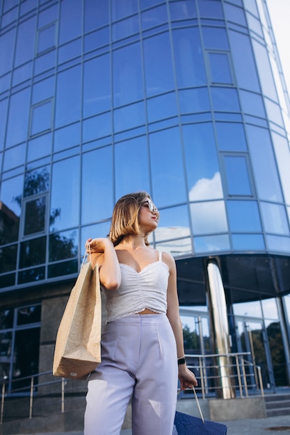 Free photo young woman by the shopping center