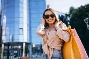 Free photo young woman by the shopping center