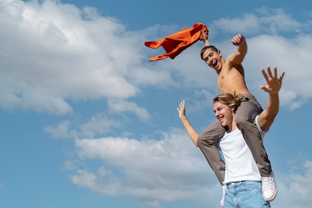 Free photo young woman caring her male friend in an outdoor field