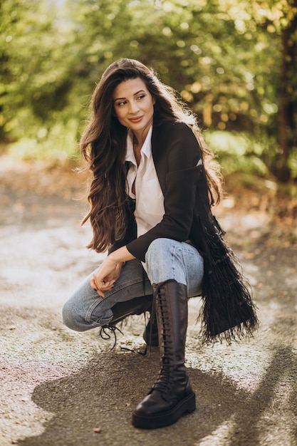 Young woman in casual outfit walking in the street