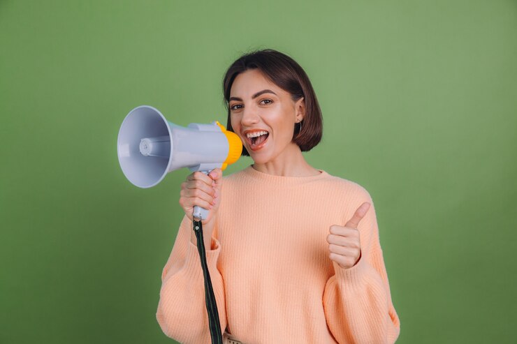 Free Photo young woman in casual peach sweater isolated on green olive color wall