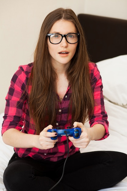 Young woman in casual playing videogame