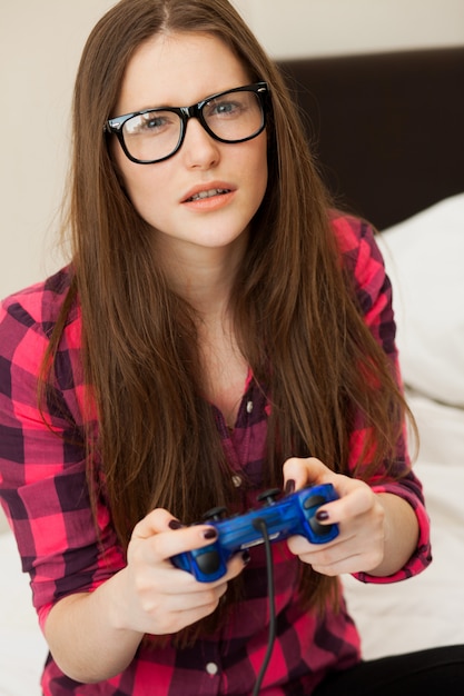 Young woman in casual playing videogame