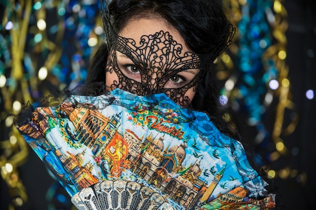 Young woman celebrating venetian carnival
