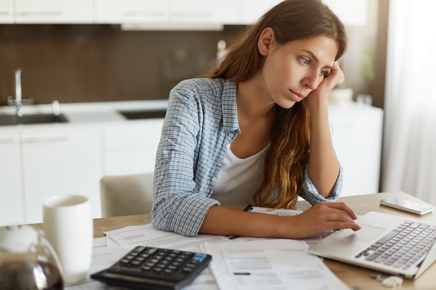 Young woman checking her budget and doing taxes