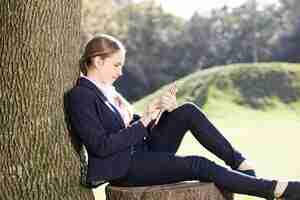 Free photo young woman checking her email outdoors
