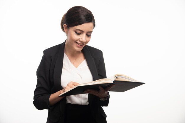 Young woman checking notes on white background. High quality photo