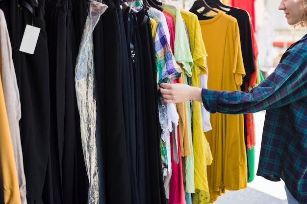 Young woman choosing different outfits