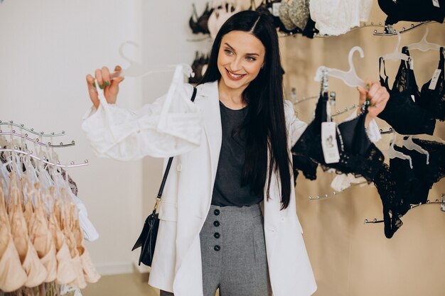 Young woman choosing underwear at shopping mall