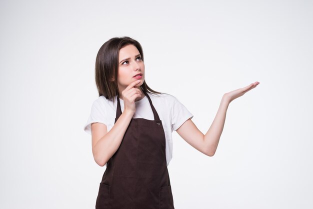 Young woman cleaner with hand show with blank sign isolated