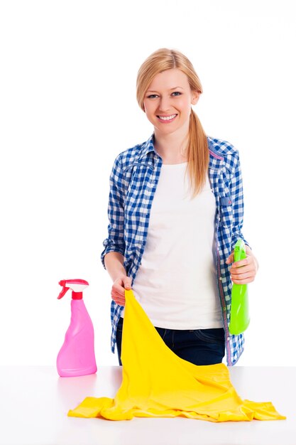 Young woman cleaning stained shirt