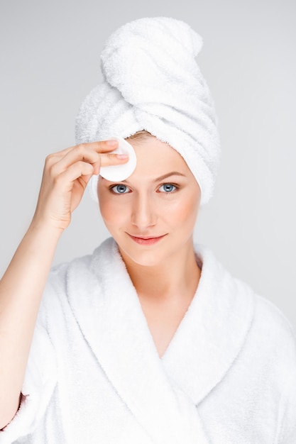 Young woman cleansing face after makeup