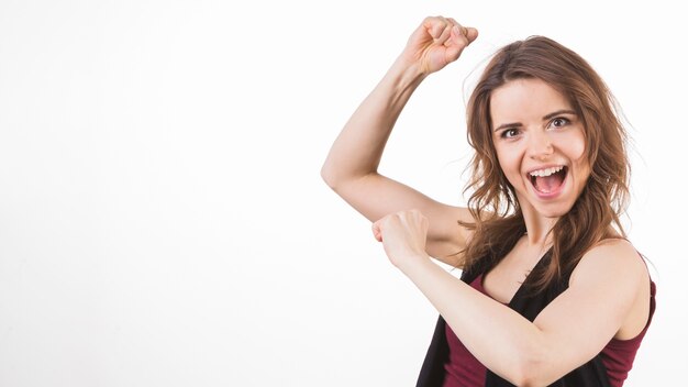 Young woman clenching her fists in excitement