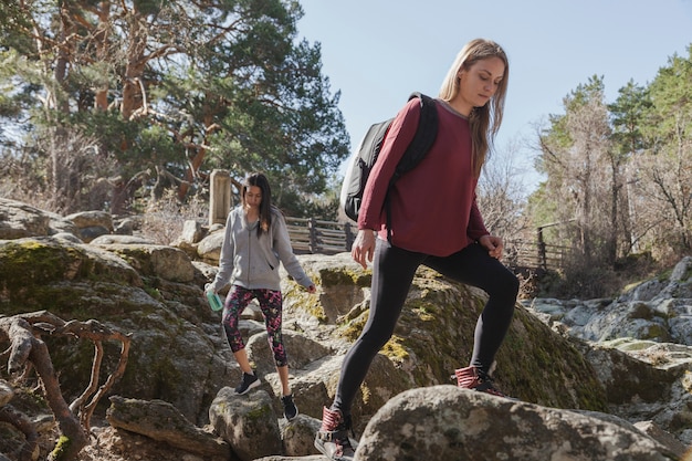 Young woman climbing a rock