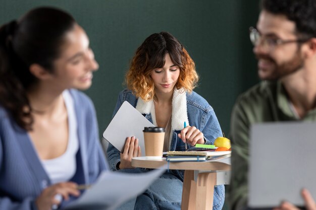 Young woman comparing her notes with information from the internet