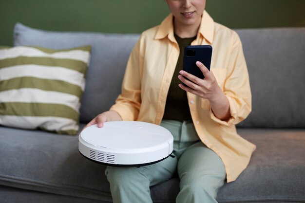 Young woman configuring electronic cleaning device