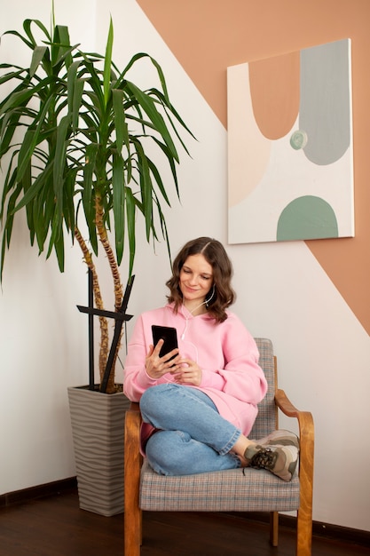 Free photo young woman connected to her smartphone