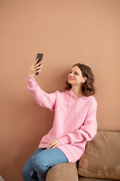 Young woman connected to her smartphone