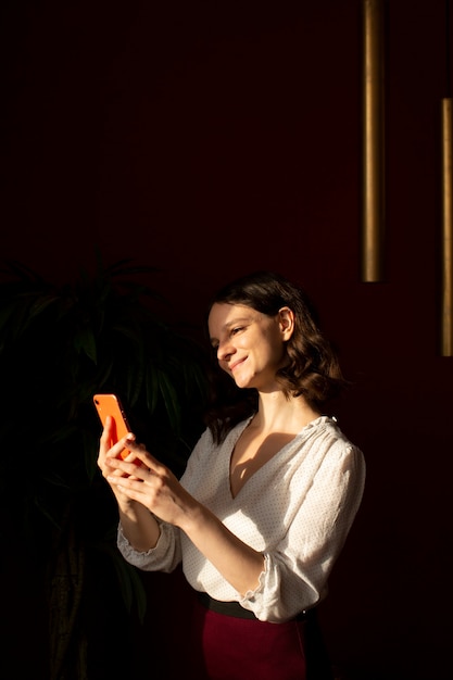 Free photo young woman connected to her smartphone