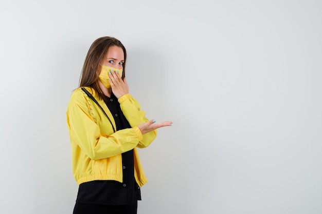 Young woman covering mouth with hand