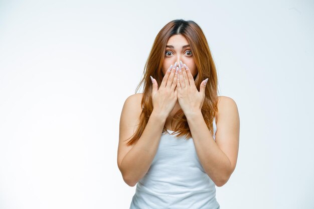 Young woman covering mouth with hands