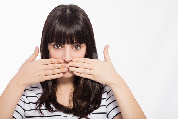 Young woman covering mouth