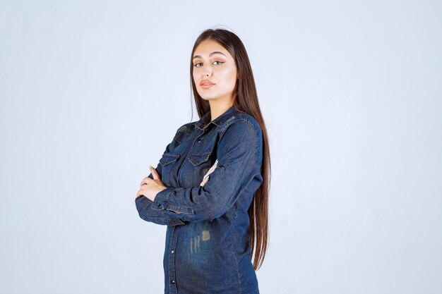 Young woman crossing arms and giving professional poses