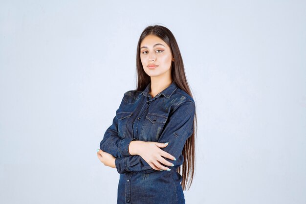Young woman crossing arms and giving professional poses