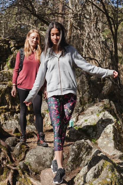 Free photo young woman crossing a trunk