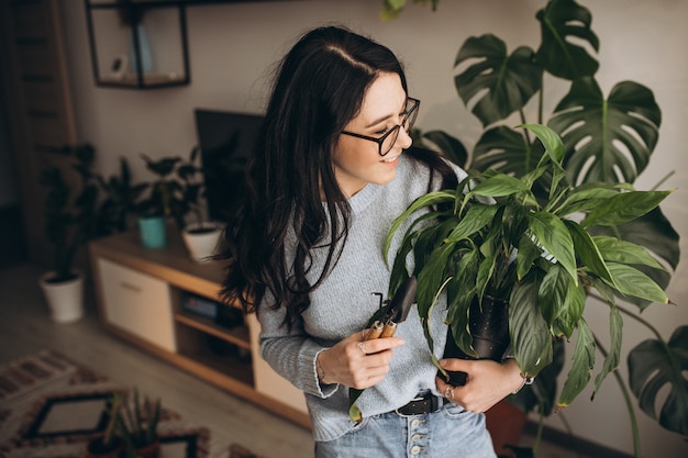 Young woman cultivating plants at home