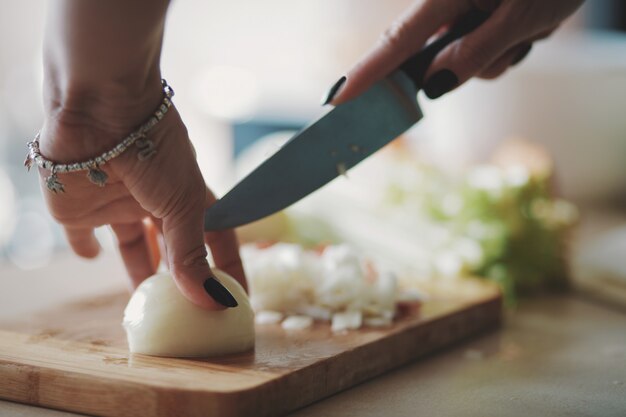 Young woman cutting vegetables