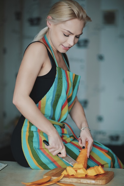 Young woman cutting vegetables