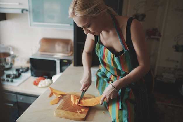 Young woman cutting vegetables