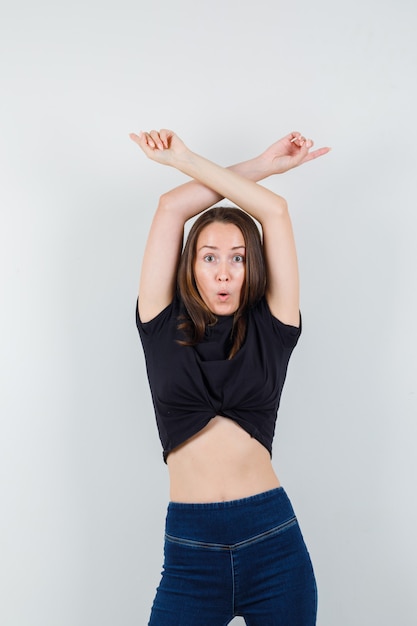 Young woman dancing in black blouse and looking focused