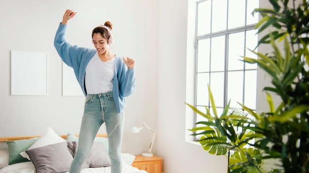 Free photo young woman dancing at home