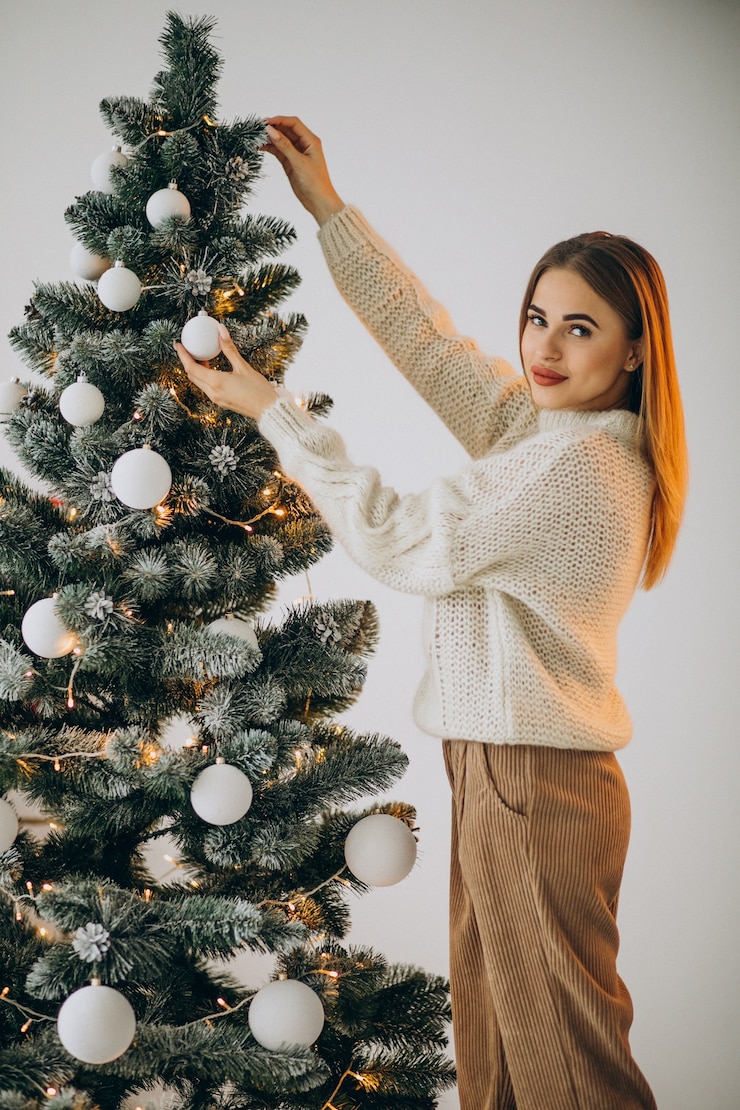 Free Photo young woman decorating christmas tree
