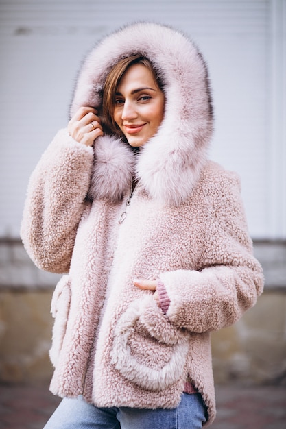 Free photo young woman demonstrating cloths outside in street