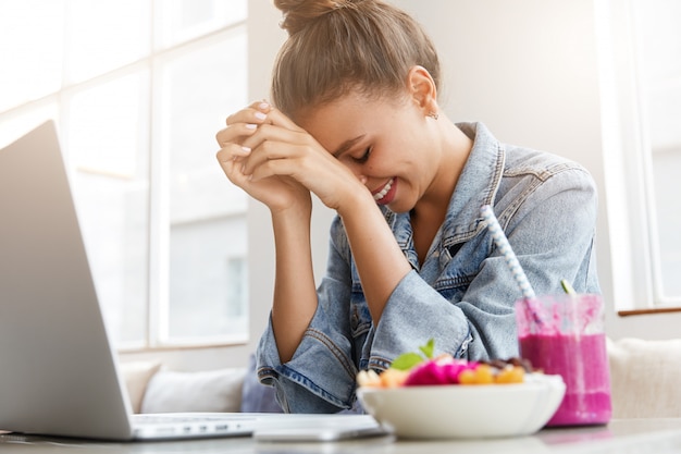 Young woman in denim jacket in cafe