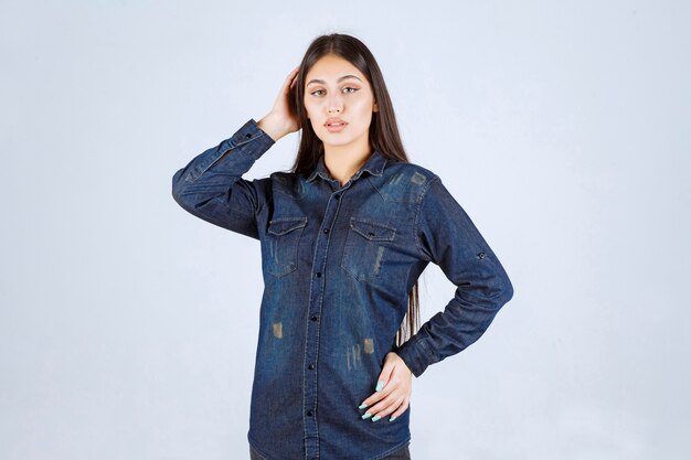 Young woman in denim shirt giving neutral and seductive poses without reactions