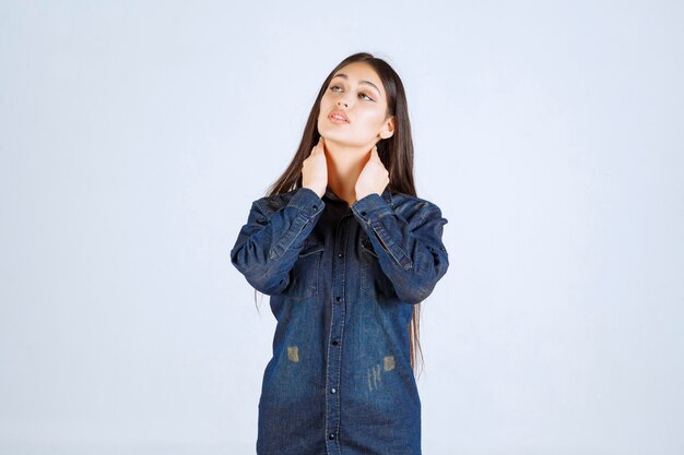 Young woman in denim shirt giving neutral and seductive poses without reactions