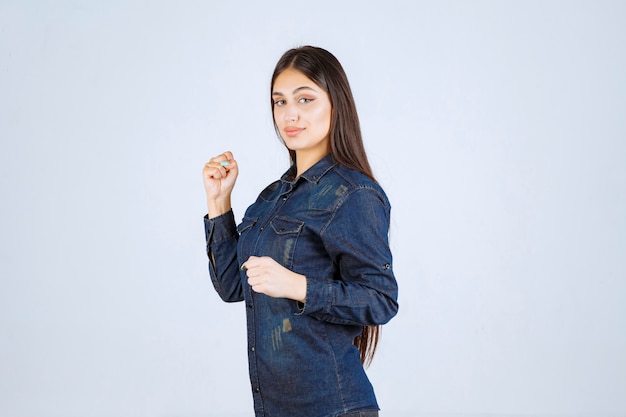 Free photo young woman in denim shirt running from the place