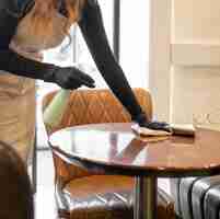 Free photo young woman disinfecting before opening