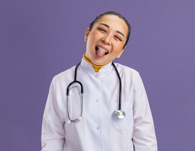 Young woman doctor     happy and joyful sticking out tongue