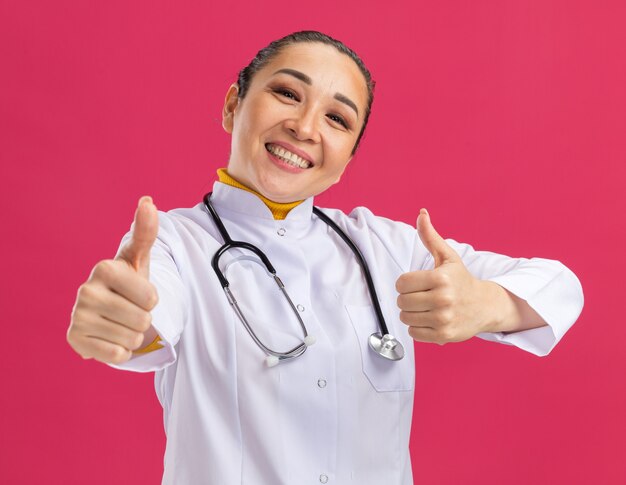 Young woman doctor     smiling with happy face showing thumbs up