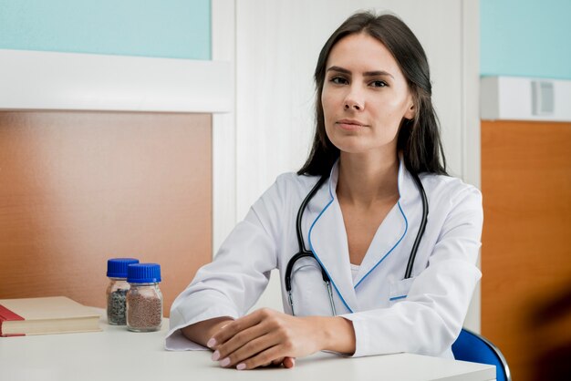 Young woman doctor at table