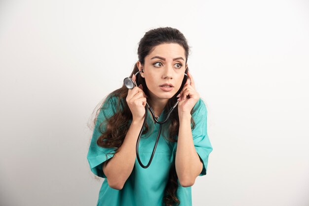 Young woman doctor in uniform with stethoscope.