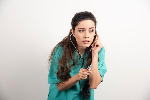 Young woman doctor in uniform with stethoscope.