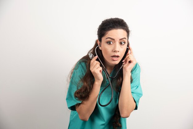 Young woman doctor in uniform with stethoscope.