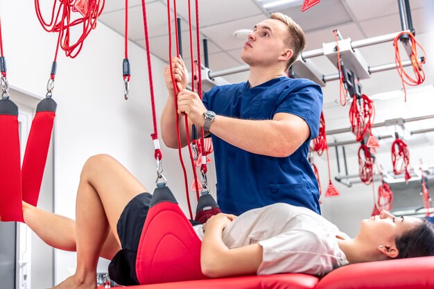 A young woman at a doctors appointment with a rehabilitologist